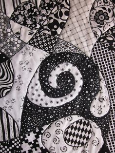 black and white quilted material with designs on it