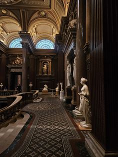 the inside of a building with statues and windows