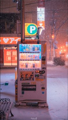 a vending machine sitting in the middle of a snow covered street