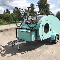 a small trailer with a bike on the back of it's seat and wheels