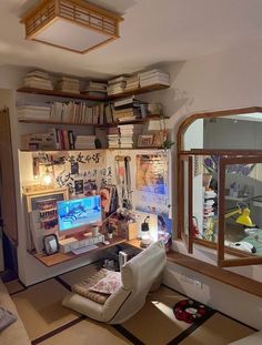 a room with a desk, chair and bookshelf filled with various items in it