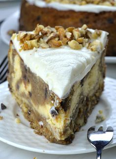 a piece of cake on a plate with a fork next to it and another slice in the background