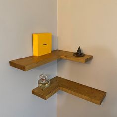 two wooden shelves with one yellow box on top and the other empty shelf below them