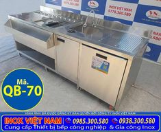 a stainless steel kitchen with two sinks and no faucets on the counter top