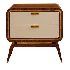 a white and brown dresser sitting on top of a wooden table