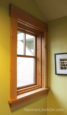 the corner of a window in a yellow room