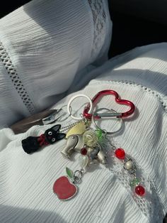 a bunch of key chains sitting on top of a white cloth covered car back seat