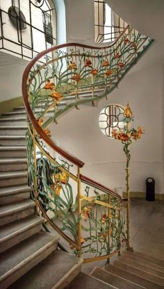 a spiral staircase with flowers painted on it