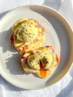 two open faced sandwiches on a plate with mayonnaise and carrots in the middle