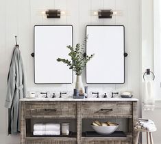 two mirrors are above the double sinks in this bathroom