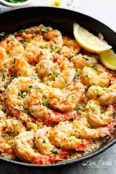 a skillet filled with shrimp and garnished with parsley on the side