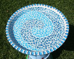 a blue and white frisbee sitting on top of green grass