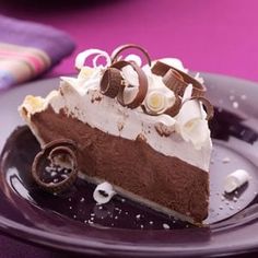 a piece of chocolate pie on a plate with whipped cream and oreo crusts