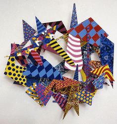 a bunch of different colored kites on a white surface with polka dots and stripes