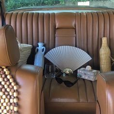 the back seat of a car with a fan, vase and other items on it