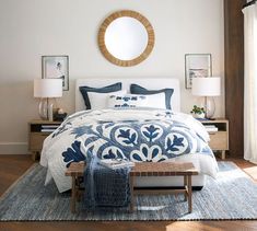 a bed with blue and white comforter in a bedroom