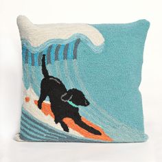 a pillow with a black dog surfing on a wave and the words, surfing dog ocean pillow