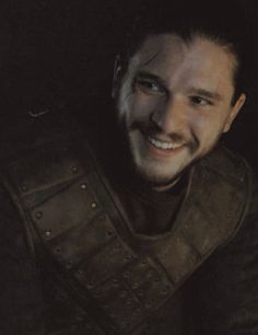 a man in armor smiling at the camera