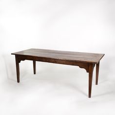 a wooden table sitting on top of a white floor