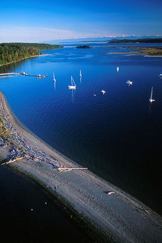 an aerial view of boats on the water