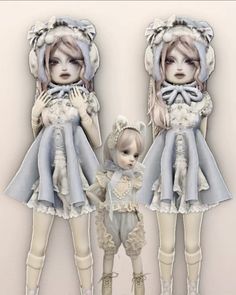 two dolls are standing next to each other