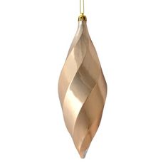 a gold ornament hanging on a white background