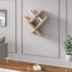 a living room scene with focus on the bookshelf and wall mounted bookcase