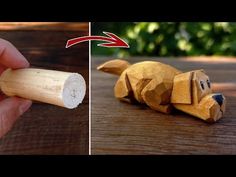 a wooden dog laying on top of a table next to a hand holding a piece of wood