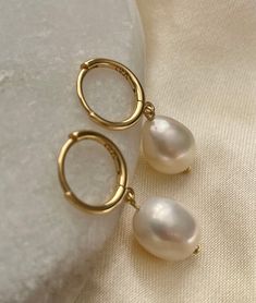 ❀Pearl❀ Earrings  Dress your ears in pure elegance with our Gold-Plated Sterling Silver Freshwater Pearl Drop Earrings! 🌟✨ Delicate and dainty, these beauties add a touch of sophistication to any look. The lustrous pearls dance with every step, making you the star of the show. Shine on, you glamorous pearl lover!   ♥ One pair   ♥ Gold Plated Sterling Silver   ♥ One Freshwater pearls on each earring  ♥ Total length approx. 2.8cm   All Freshwater Pearls vary slightly in size and shape  Keep your sterling silver stunners shining like the stars they are! ✨ Here's the 411: *Wear Often: Yep, you read it right! Regular wear helps prevent tarnish. *Avoid Sweat & Sprays: Take off your silver babes before hitting the gym or spraying on perfume. They like to keep it dry. *Store Smart: Pop them in a Pearl Drop Earrings Aesthetic, It Girl Earrings, Pearl Hoop Earrings Gold, Gold Earrings With Pearls, Gold Drop Pearl Earrings, Hoops With Pearls, White Gold Pearl Earrings, Basic Earrings, Gold And Pearl Earrings