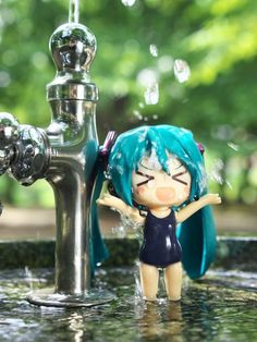 a doll is standing in the water next to a faucet with bubbles coming out of it