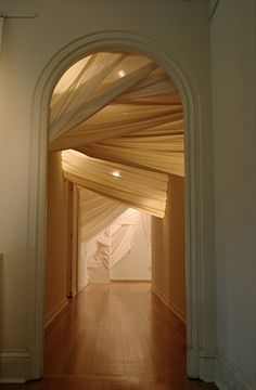 an archway leading into a room with wood floors