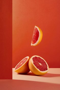 two grapefruits cut in half on a table