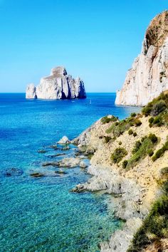 an ocean view with rocks in the background