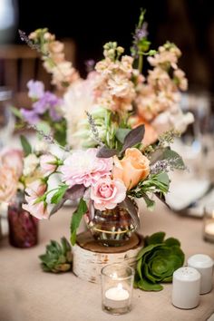 a table topped with lots of flowers and candles