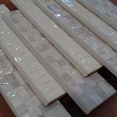 several pieces of white plastic sitting on top of a wooden table next to each other