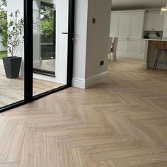 an empty room with wooden floors and sliding glass doors leading to the outside patio area