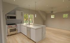 an empty kitchen with wood floors and white cabinets