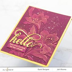 a close up of a greeting card on a marble surface with the word hello written in gold