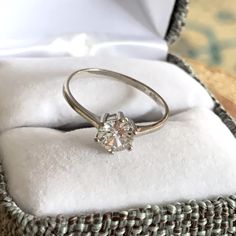 an engagement ring is sitting in a gift box