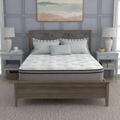 an image of a bedroom setting with mattress and pillows