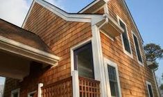 a brown house with white trim and windows