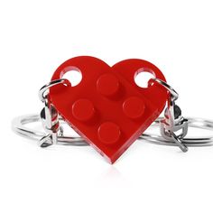 a red heart shaped ring with two metal rings around it and the middle one is made out of legos