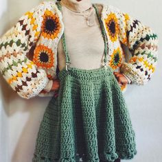 a crocheted granny outfit with sunflowers on it and a sweater over the shoulders