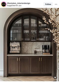 an arch - shaped cabinet with glass doors and shelves is featured in this instagram