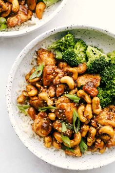 two bowls filled with chicken, broccoli and rice on top of a table