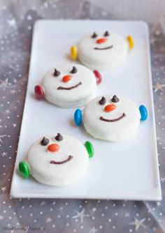 three frosted snowmen on a white plate