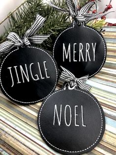 two black and white ornaments with merry noel on them