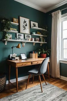 a home office with green walls and wooden desk in front of a window, framed pictures on the wall