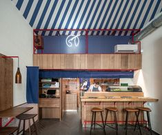 the interior of a restaurant with wooden tables and stools