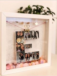 a white frame with pictures hanging from it's sides